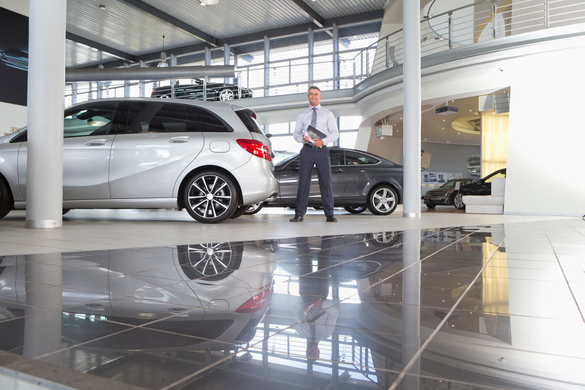 An advisor in a dealership showroom